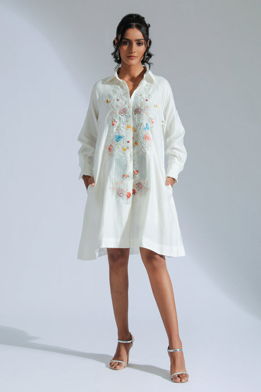 White shirt dress with intricate lace, beadwork, and charming motifs. 