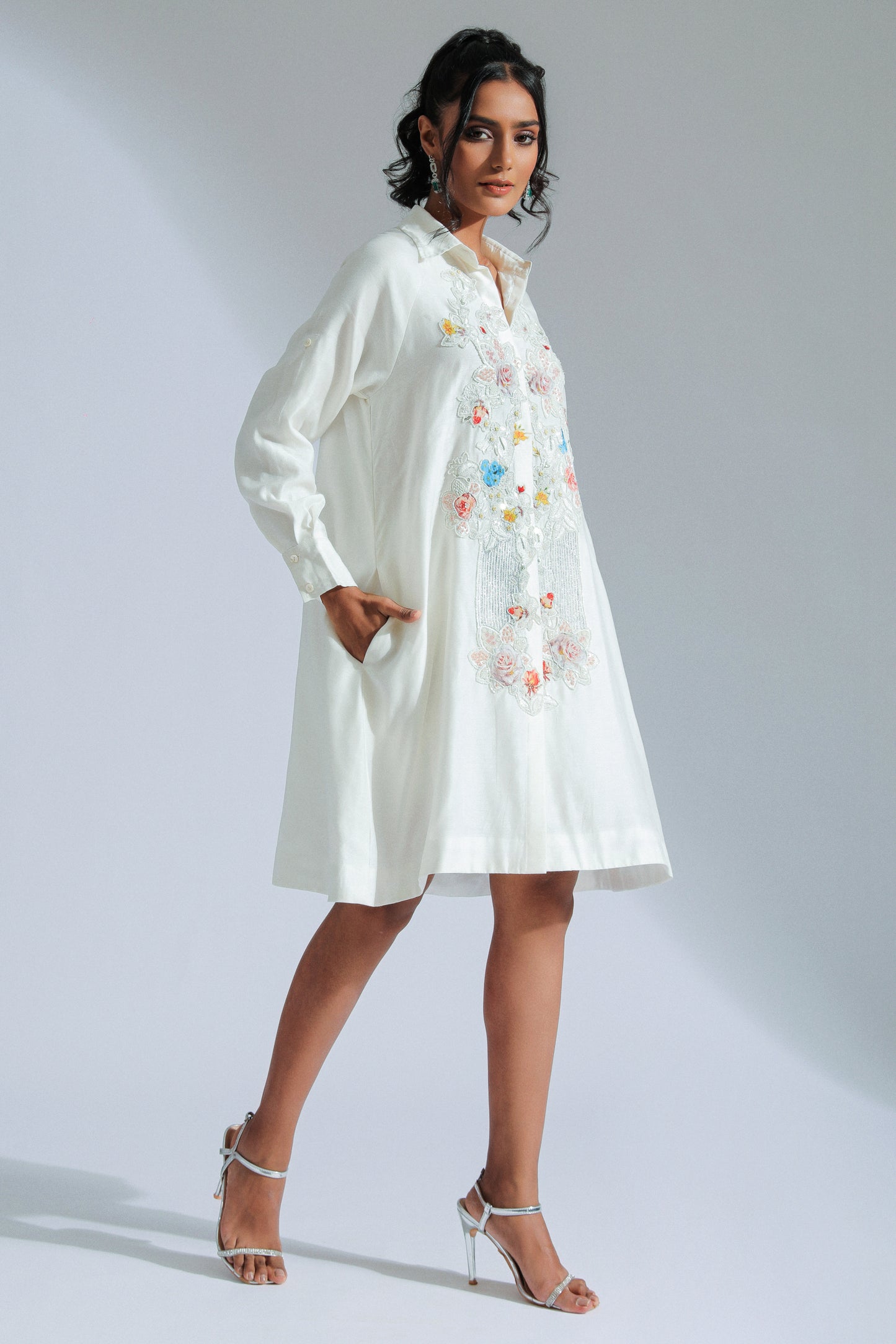 White shirt dress with intricate lace, beadwork, and charming motifs. 