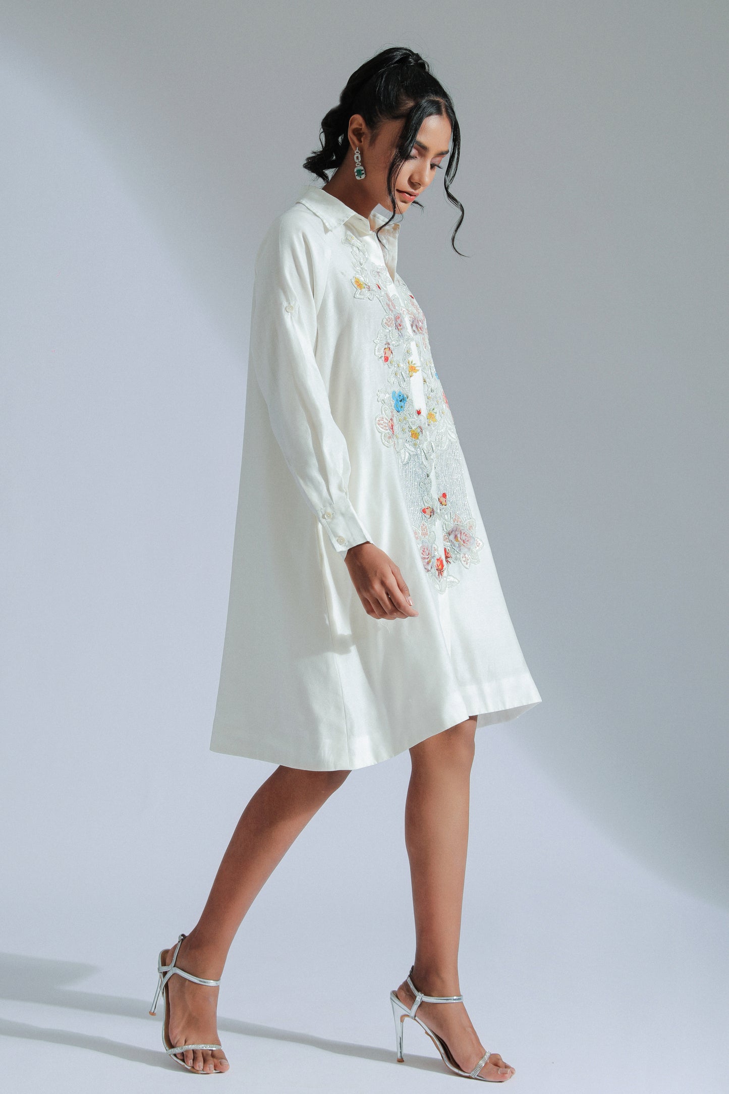 White shirt dress with intricate lace, beadwork, and charming motifs. 