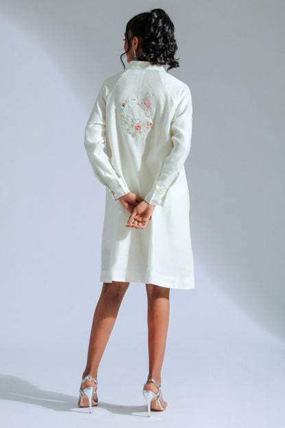 White shirt dress with intricate lace, beadwork, and charming motifs. 